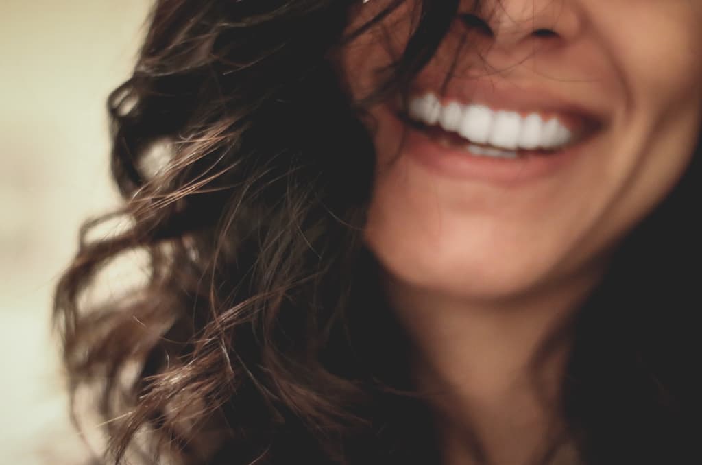 A woman's face with a smile.